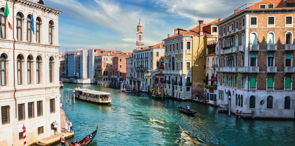 boat on water between buildings during daytime