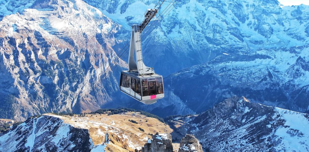 bird's eye view of ski lift over mountains during winter